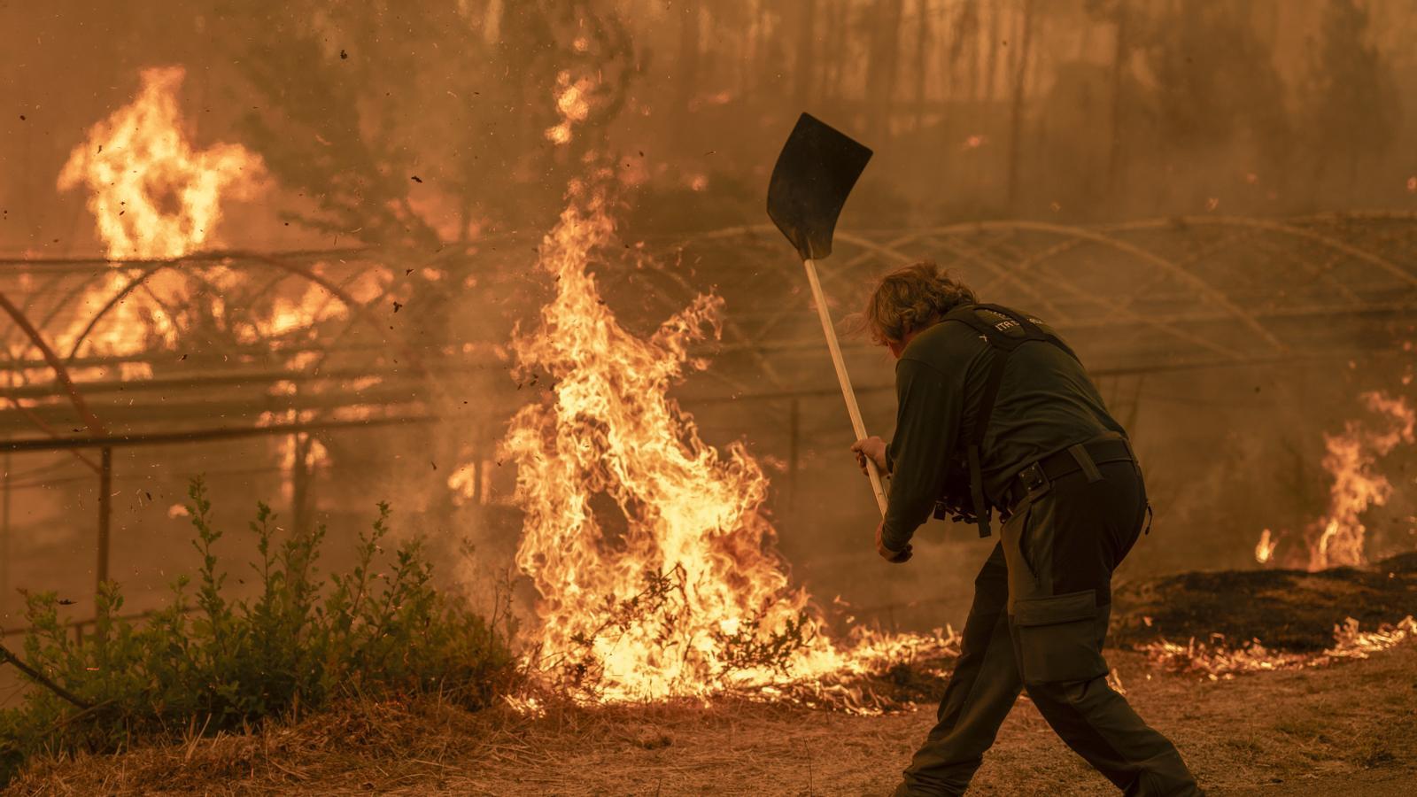 A forest ranger participates in the firefighting efforts in Carballeda de Avia. The wave of wildfires continues to devastate northwestern Spain, with victims, evacuees, and thousands of hectares burned.